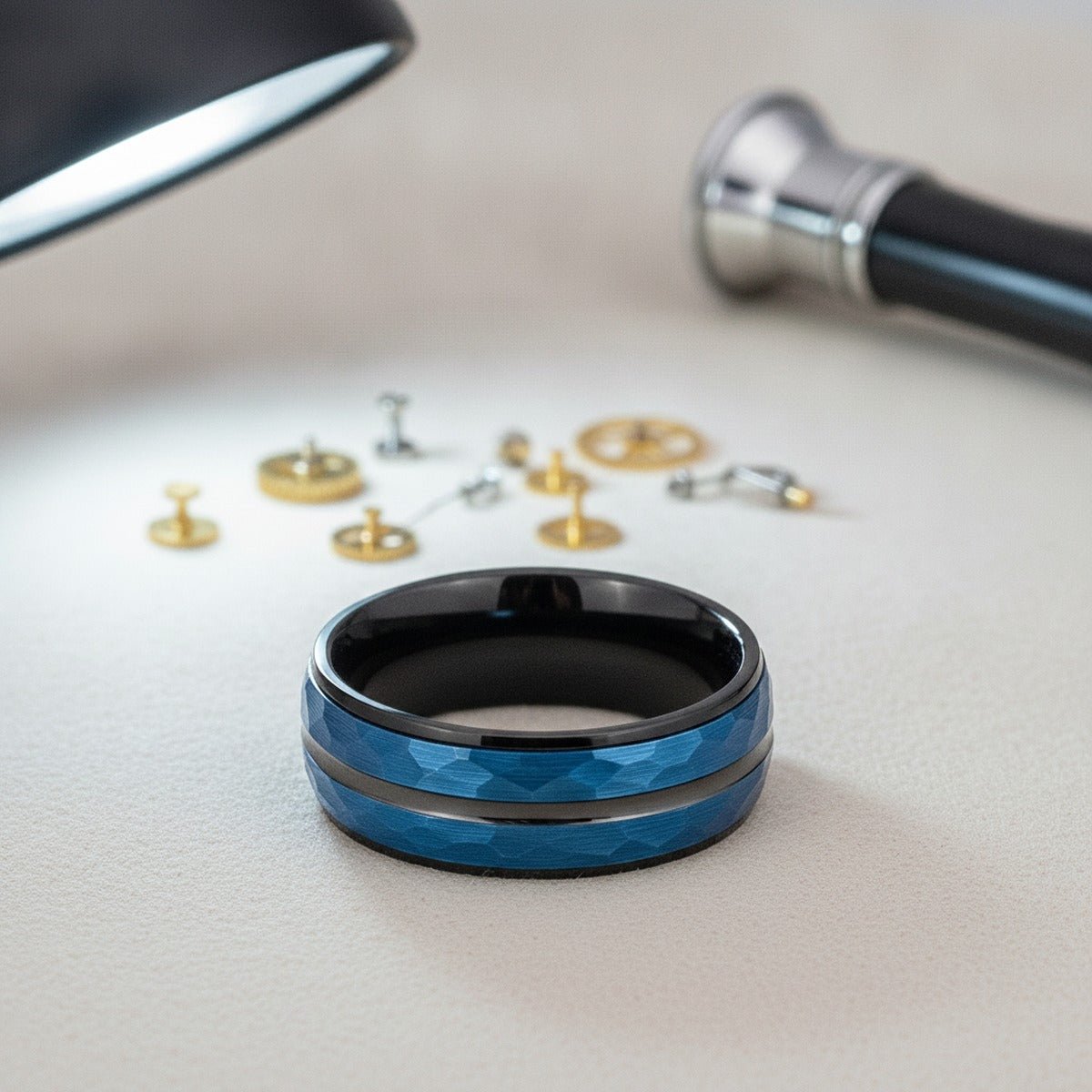 Aydins HARLO | Black Tungsten Blue Hammered Center Wedding Ring 8mm lifestyle scene, watchmaker bench