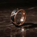 HILVEN — Luxury 3/4 angle on dark marble — men's tungsten wedding ring.