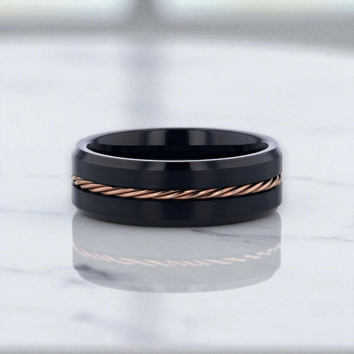 Close-up of brushed braided rose gold inlay on tungsten wedding band