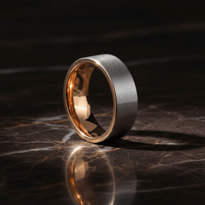 ICON — Luxury 3/4 angle on dark marble — men's tungsten wedding ring.