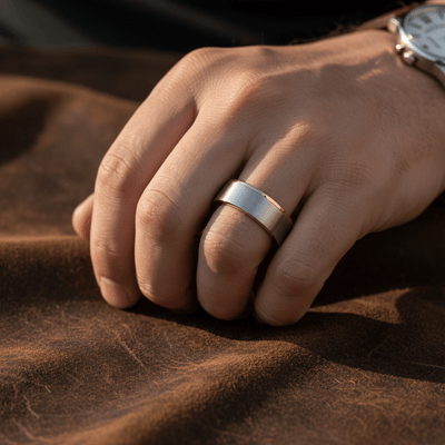 ICON — Lifestyle photo on hand — men's tungsten wedding ring.