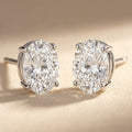 IGI certified lab-grown diamond stud earrings, oval F+/VS+ 14k white gold, studio hero shot