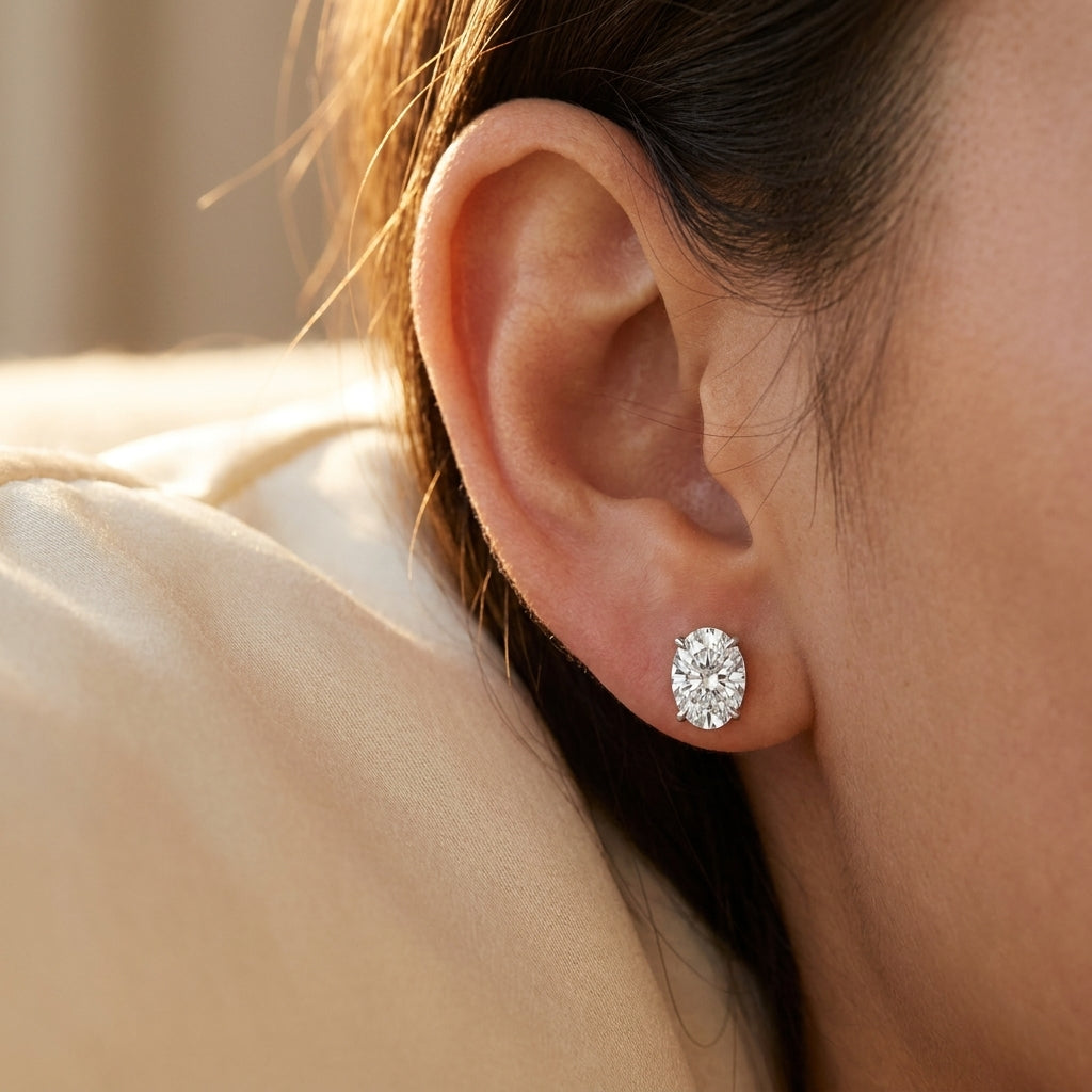 IGI certified lab-grown diamond stud earrings, oval F+/VS+ worn on earlobe, lifestyle photo