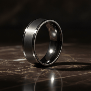 IGNITION — Luxury 3/4 angle on dark marble — men's tungsten wedding ring.