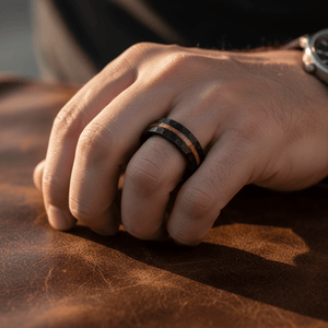 INFERNAL — Lifestyle photo on hand — men's tungsten wedding ring.