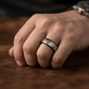 IRONBARK — Lifestyle photo on hand — men's tungsten wedding ring.