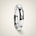 ISABELLA domed white tungsten wedding band with three small diamond accent stones set in a row on the center of the band and polished edges, studio hero shot