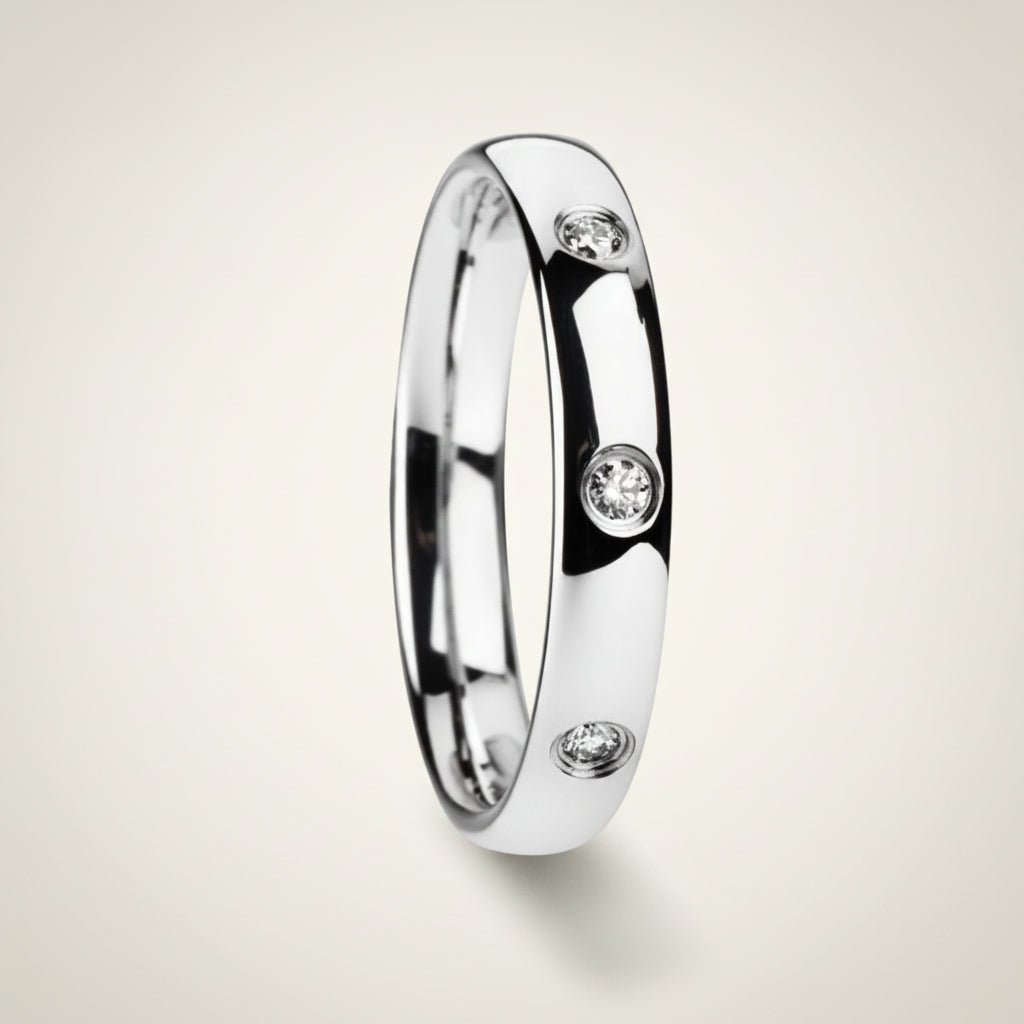 ISABELLA domed white tungsten wedding band with three small diamond accent stones set in a row on the center of the band and polished edges, studio hero shot