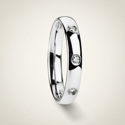 ISABELLA domed white tungsten wedding band with three small diamond accent stones set in a row on the center of the band and polished edges, studio hero shot