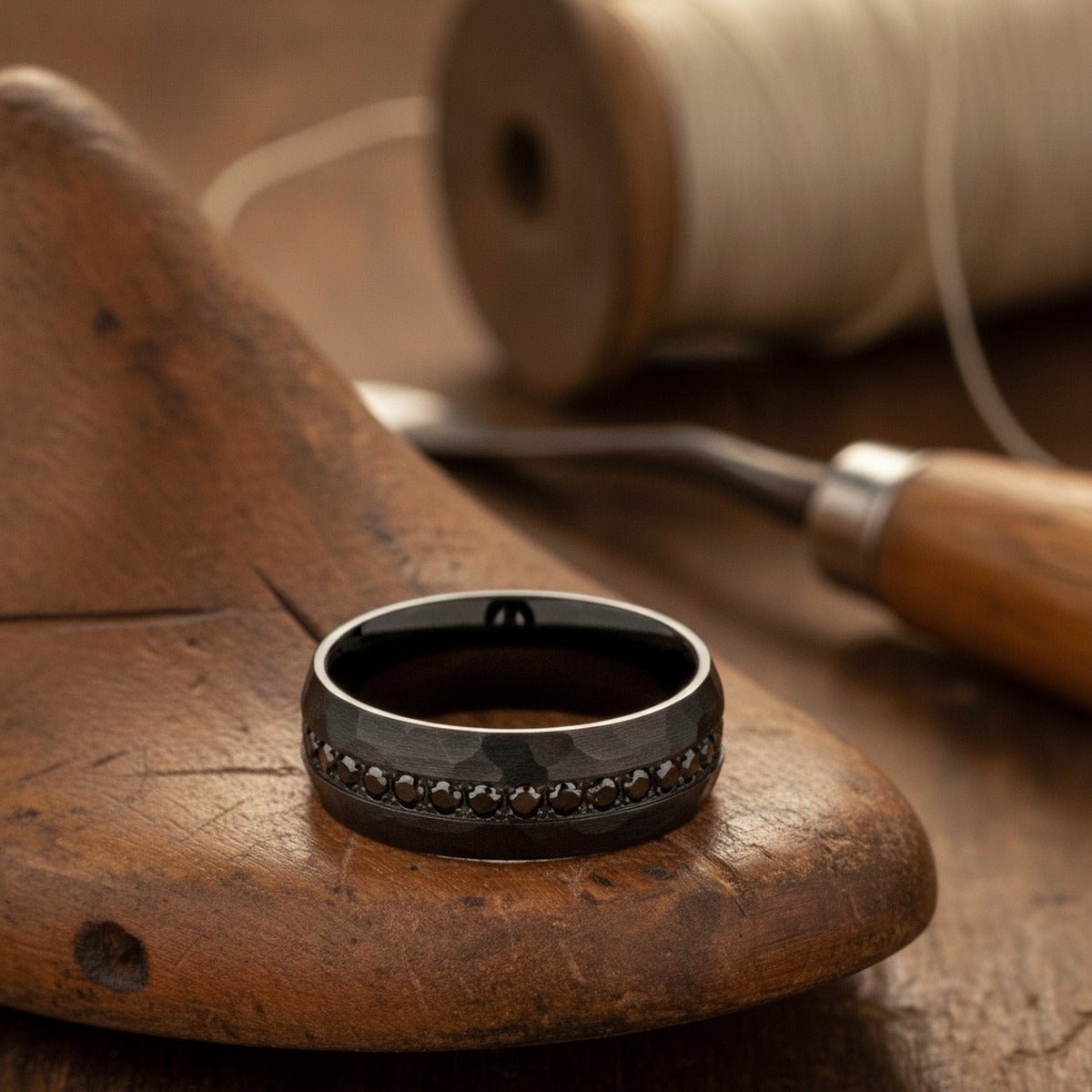 Aydins JUNCOS | Hand-Hammered Black Tungsten Black CZ Eternity Wedding Ring 8mm lifestyle scene, cobbler lasts