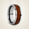 KAMEHA silver tungsten domed wedding band with koa wood inlay running around the band and polished finish, studio hero shot