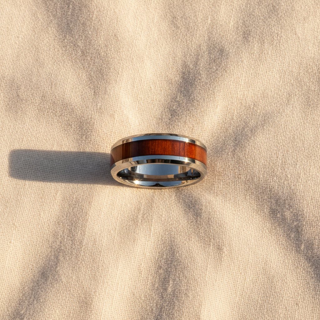 KONA silver tungsten carbide ring with hawaiian koa wood inlay running around the band and polished beveled edges macro detail overhead flat lay