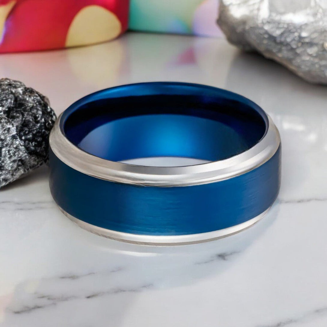 Side view of LINARD blue tungsten carbide ring with silver stepped edge.