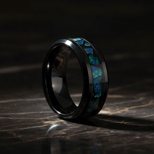 LUMINARIA — Luxury 3/4 angle on dark marble — men's tungsten wedding ring.