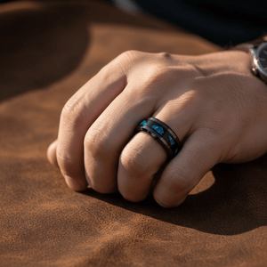 LUMINARIA — Lifestyle photo on hand — men's tungsten wedding ring.