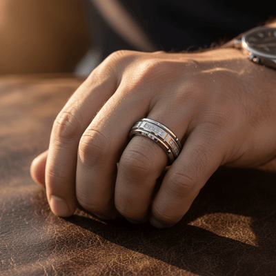LUMORA — Lifestyle photo on hand — men's tungsten wedding ring.
