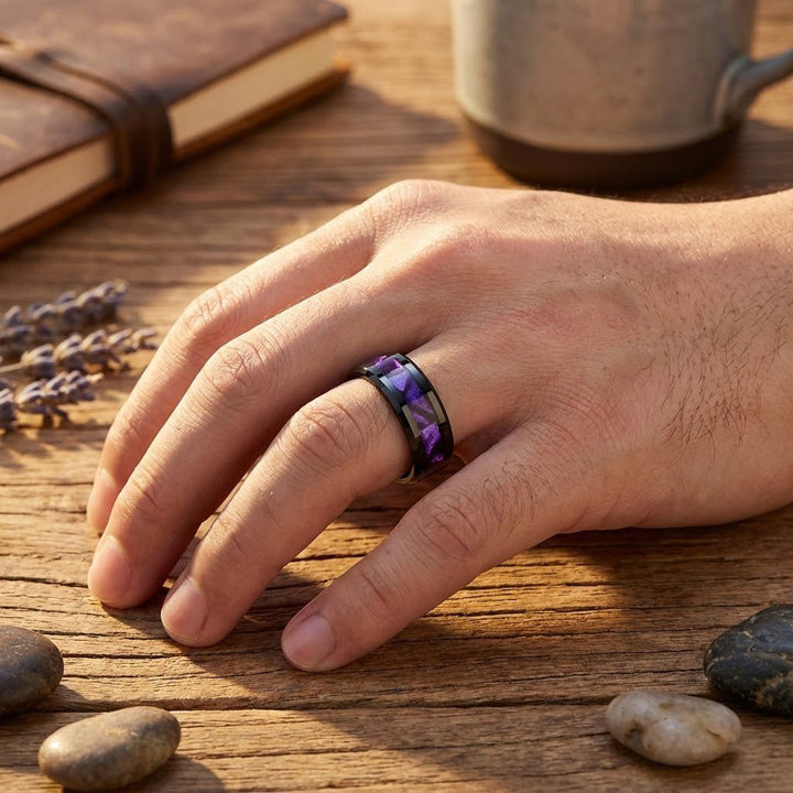 LUSTERS Black Tungsten Ring with Purple Tiger Cowrie Inlay on a ring finger.