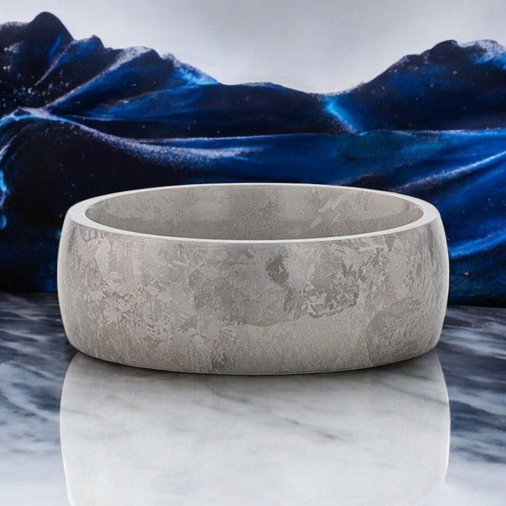 Elegant titanium ring with a unique meteorite-inspired texture, perfect for weddings or special occasions.