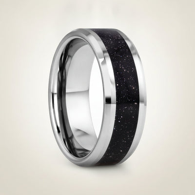MAKI polished silver tungsten wedding band with sparkling purple goldstone inlay running around the band and polished beveled edges, studio hero shot