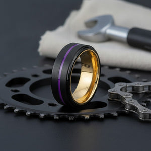 Aydins MELTON | Gold Ring, Black Tungsten Ring, Purple Groove, Stepped Edge lifestyle scene, cycling workshop