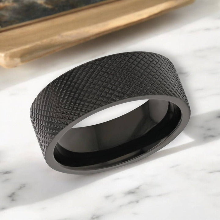 Close-up of the MIDNIGHT 8mm Black Zirconium Ring showcasing its knurled finish.