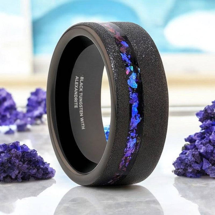 MIRAGE black tungsten ring with crushed alexandrite and goldstone inlay.