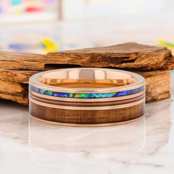 MOANA rose gold tungsten ring with vibrant abalone shell, Koa wood, and brass guitar string inlay.