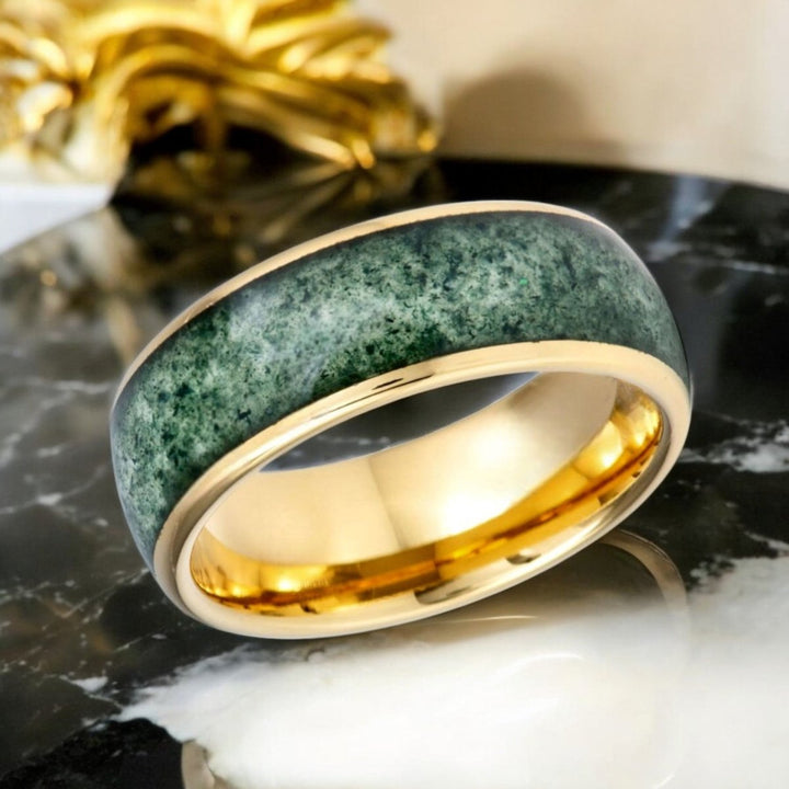 Side profile of MOOSAIRE Gold Tungsten Ring showcasing moss agate inlay.