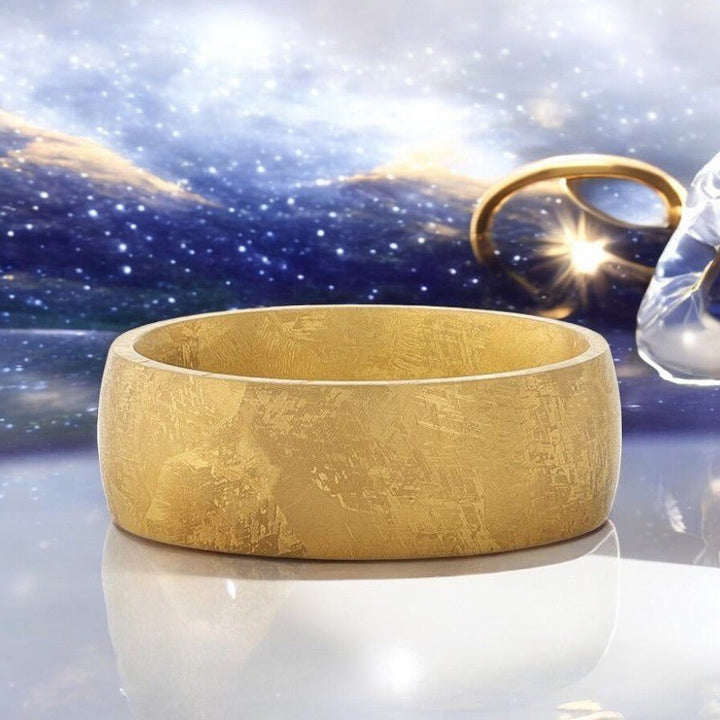 Elegant gold titanium ring with intricate meteorite texture, perfect for weddings and special occasions.