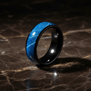 NASOS — Luxury 3/4 angle on dark marble — men's tungsten wedding ring.