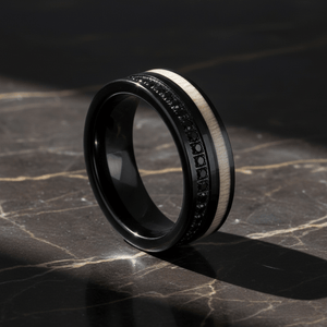 NIGHTMERE — Luxury 3/4 angle on dark marble — men's tungsten wedding ring.