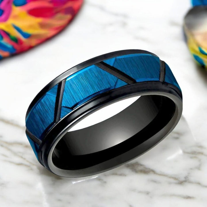 Side view showcasing the stepped edge and unique trapezoid pattern of the OBSCURA ring.