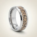 ORDOVICIAN silver tungsten carbide ring with brown dinosaur bone inlay running around the band and polished beveled edges, studio hero shot