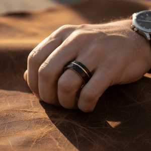 ORLANDO — Lifestyle photo on hand — men's tungsten wedding ring.