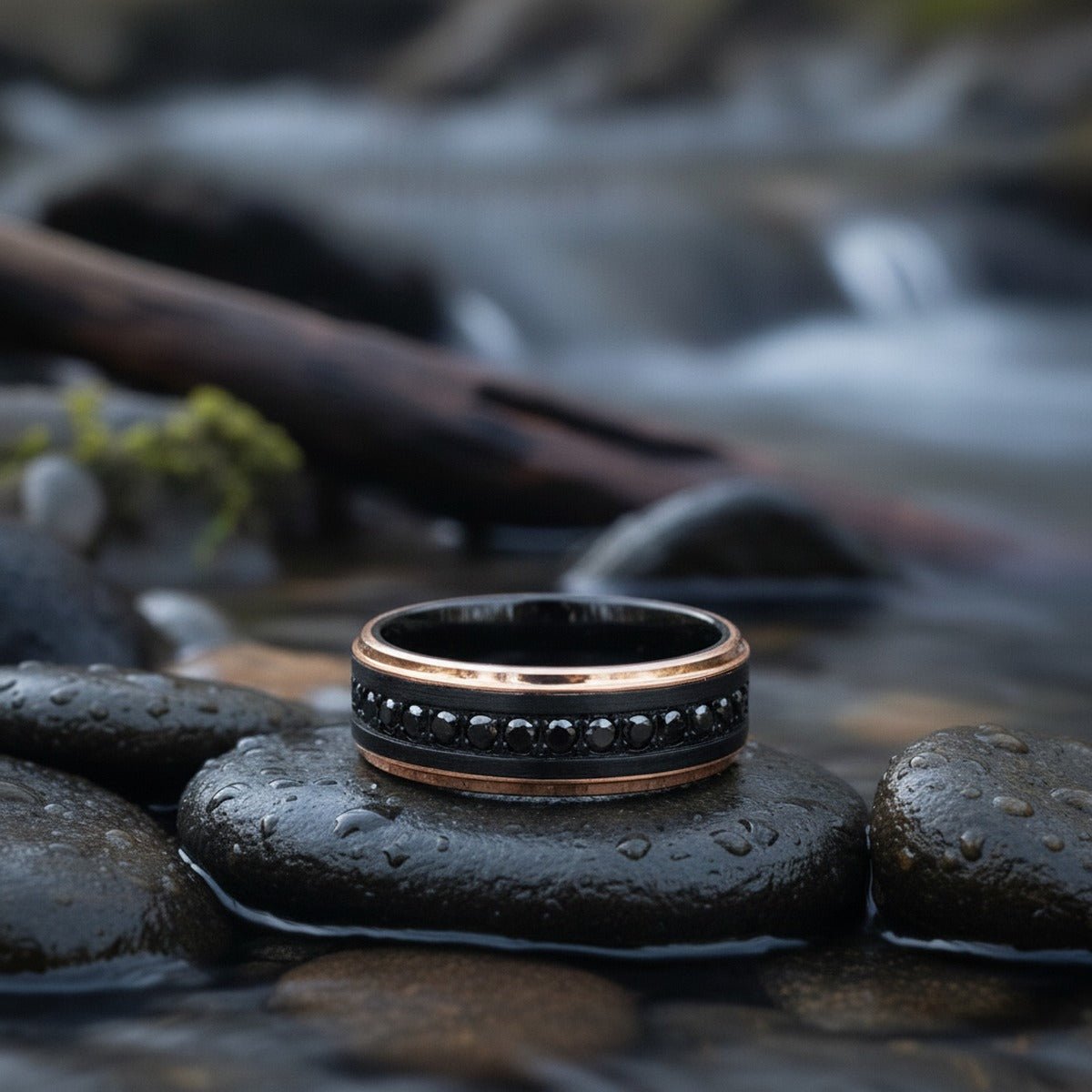 Aydins PASSINO | Black Tungsten Ring with Rose Gold Edges and Black CZ Eternity 8mm lifestyle scene, river stones