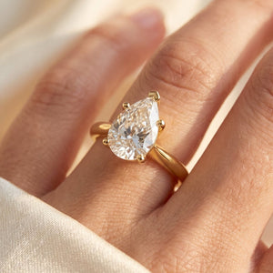 Pear lab-grown diamond solitaire engagement ring, Yellow Gold, on-finger close-up