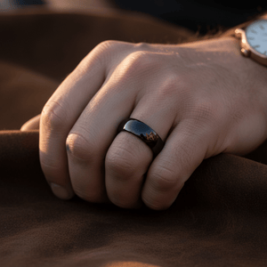 PEPPER — Lifestyle photo on hand — men's tungsten wedding ring.