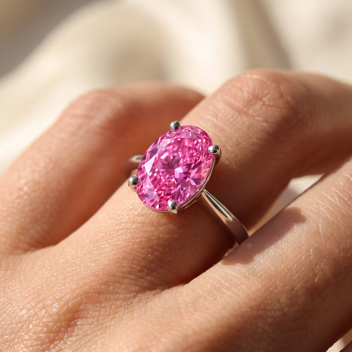 Pink Oval lab-grown diamond solitaire engagement ring, 925 Sterling Silver, on-finger close-up