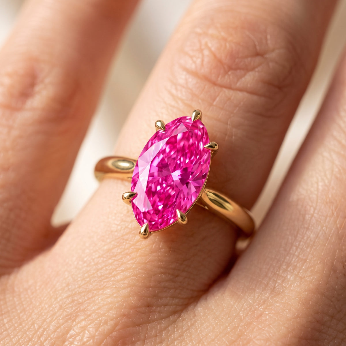 Pink Oval lab-grown diamond solitaire engagement ring, Yellow Gold, on-finger close-up
