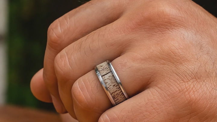 Close-up of natural antler grain in BUCK wedding band On Hand Ring Finger Vdeo