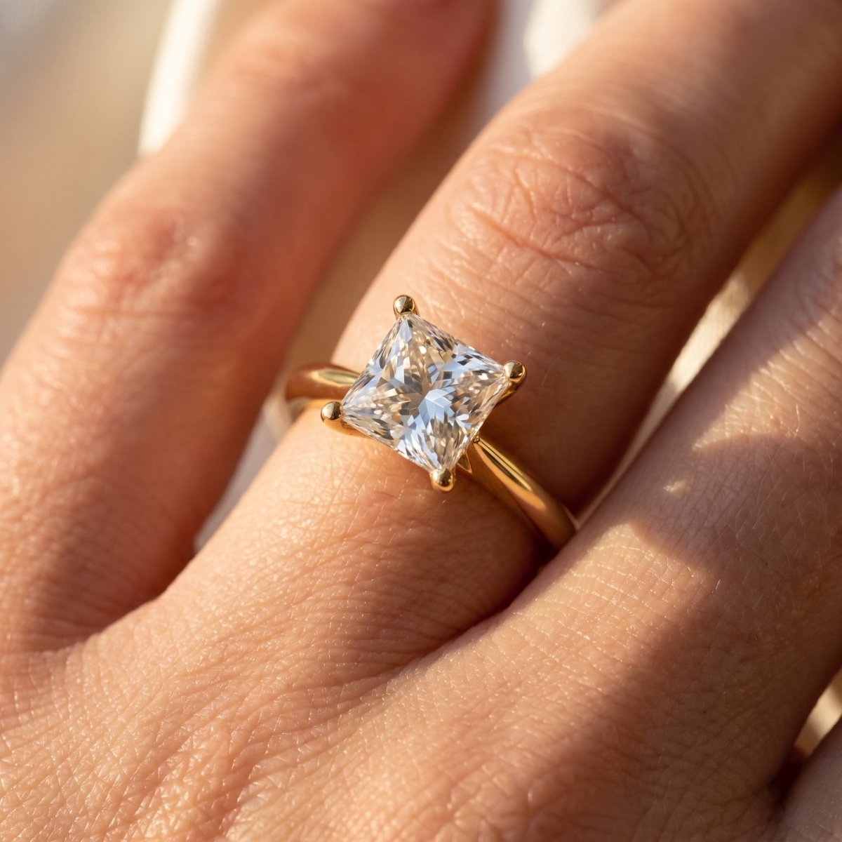 Princess lab-grown diamond solitaire engagement ring, Yellow Gold, on-finger close-up