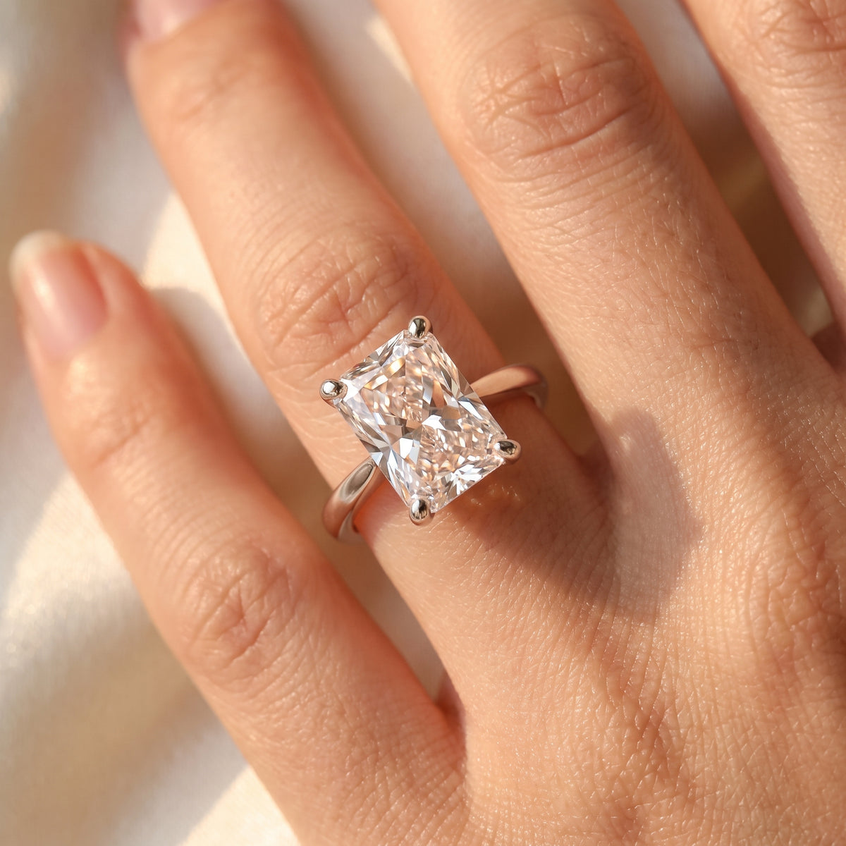 Radiant lab-grown diamond solitaire engagement ring, 925 Sterling Silver, on-finger close-up