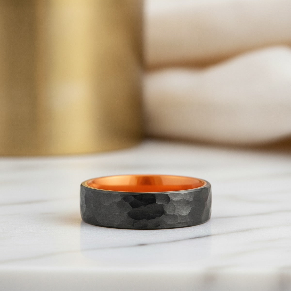 Aydins APRICOT | Orange Ring, Black Tungsten Ring, Hammered, Flat lifestyle scene, marble minimal