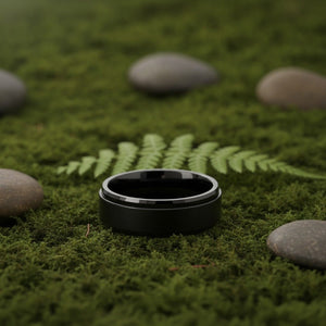 Aydins REVOLVE | Black Tungsten Fidget Spinner Wedding Ring 8mm lifestyle scene, moss forest