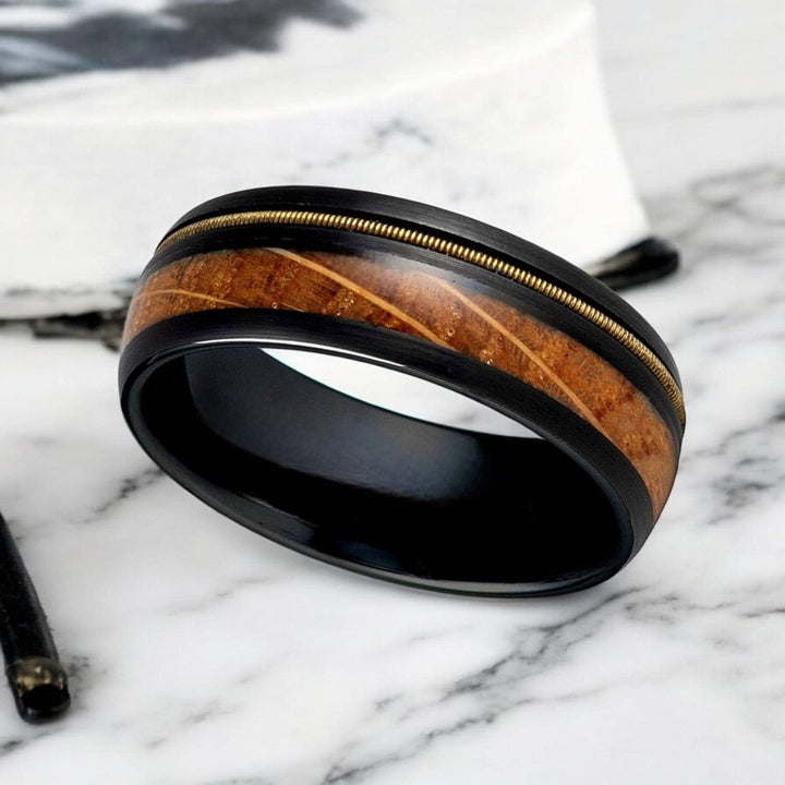 Comfort-fit black tungsten ring with polished edges and whiskey barrel inlay.