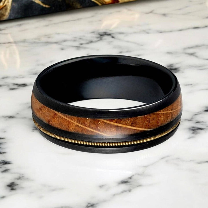 Domed black tungsten ring with unique whiskey barrel and guitar string design, 8mm width.