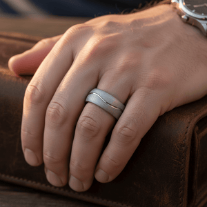 ROUGHZEN — Lifestyle photo on hand — men's tungsten wedding ring.