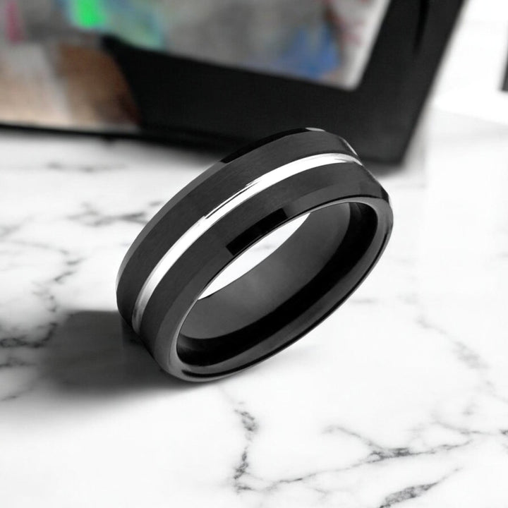 Side view of the SAGAN ring showcasing the beveled edges and silver shiny groove.