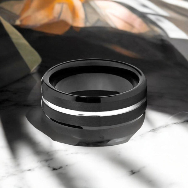 The SAGAN Black Tungsten Ring displayed with its sleek, modern design highlighted.