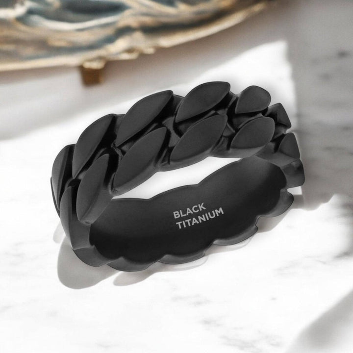 Chain-link detail on SENTINEL black zirconium ring – industrial design